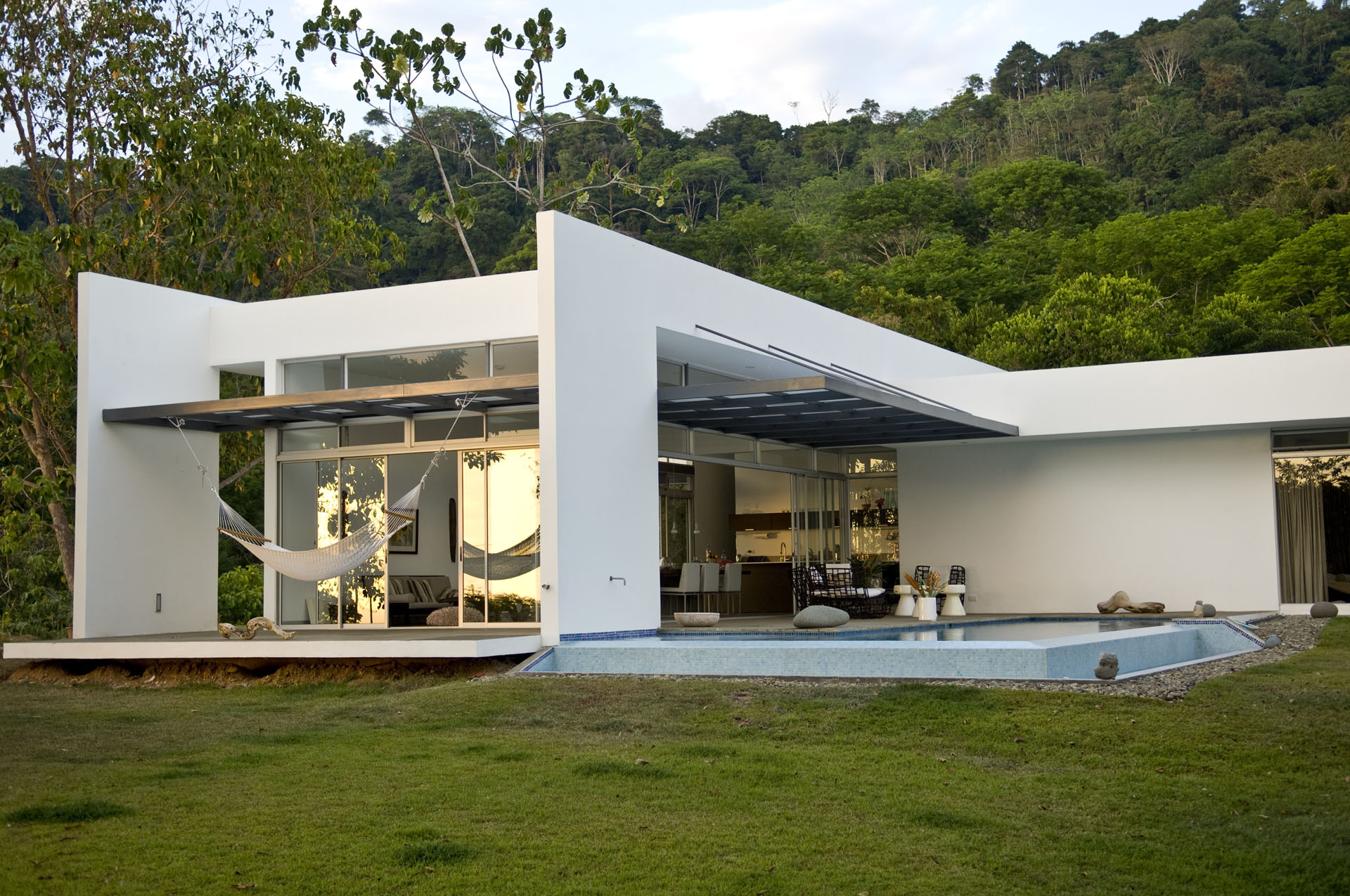 View of the social wing with a hammock on the terrace and pool in the Frowein Residence