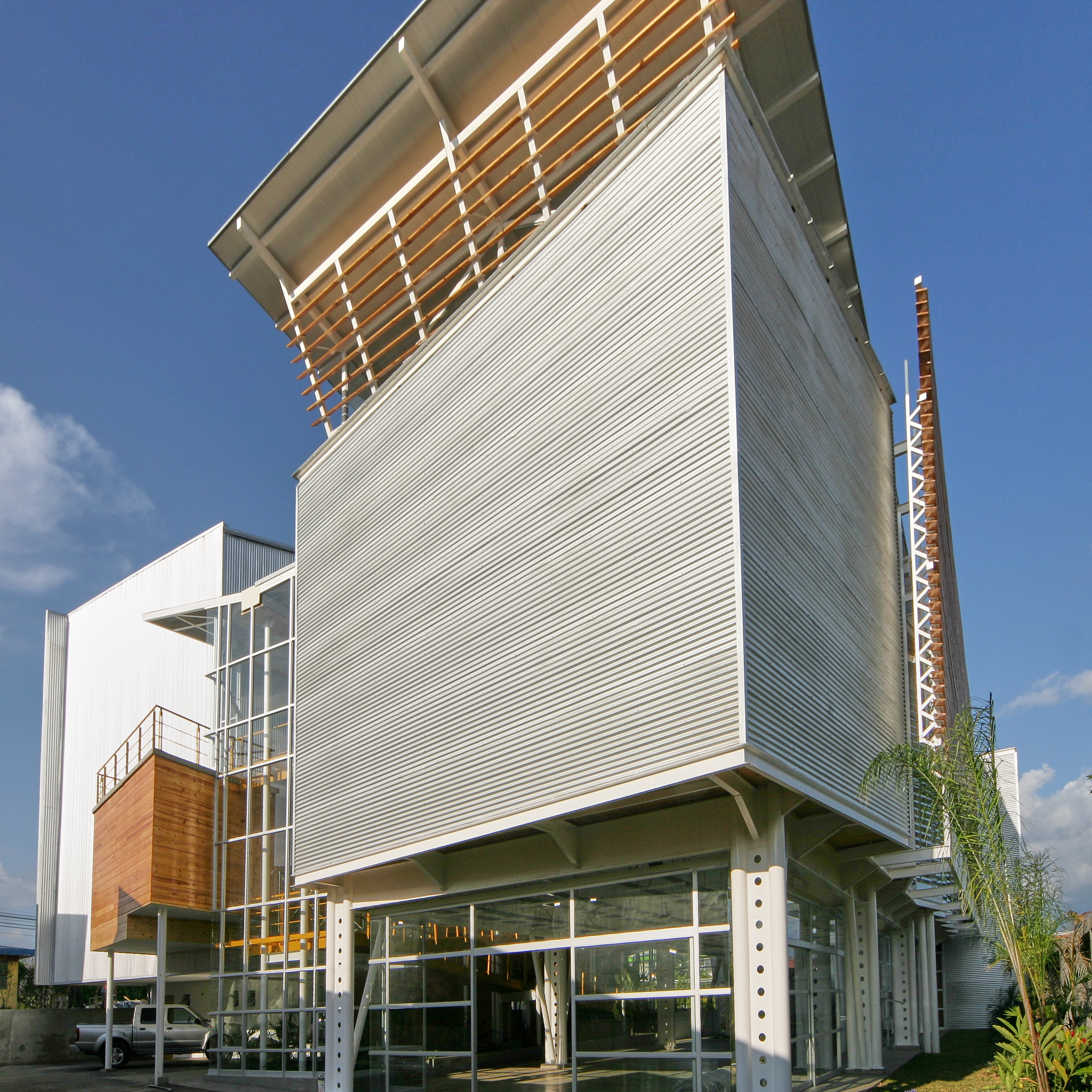 West view of Veritas University Auditorium and Workshop, depicting the separated volumes by the glass atrium