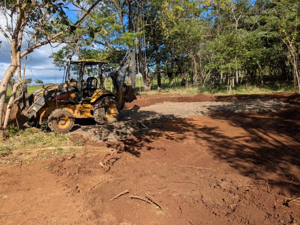 A cleared plot of land with a tractor at Casa Perro Loco’s groundbreaking site in Guanacaste