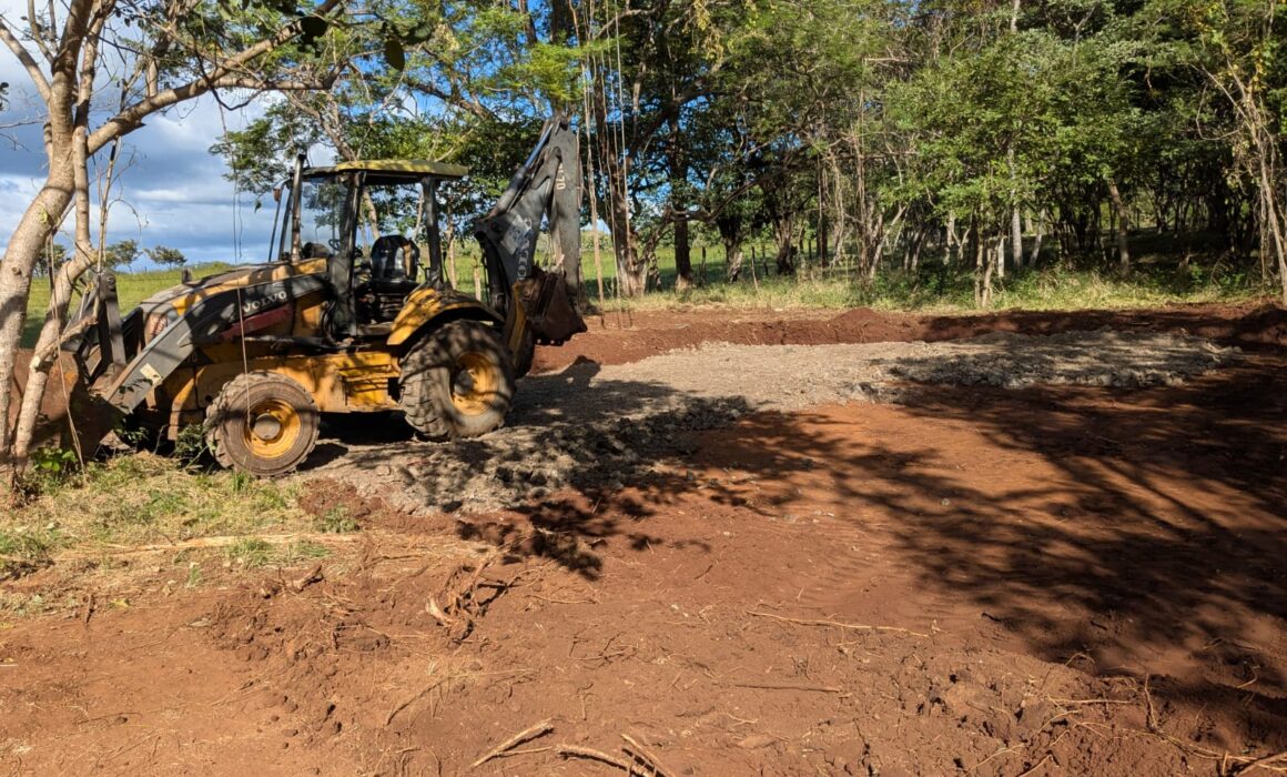 A cleared plot of land with a tractor at Casa Perro Loco’s groundbreaking site in Guanacaste