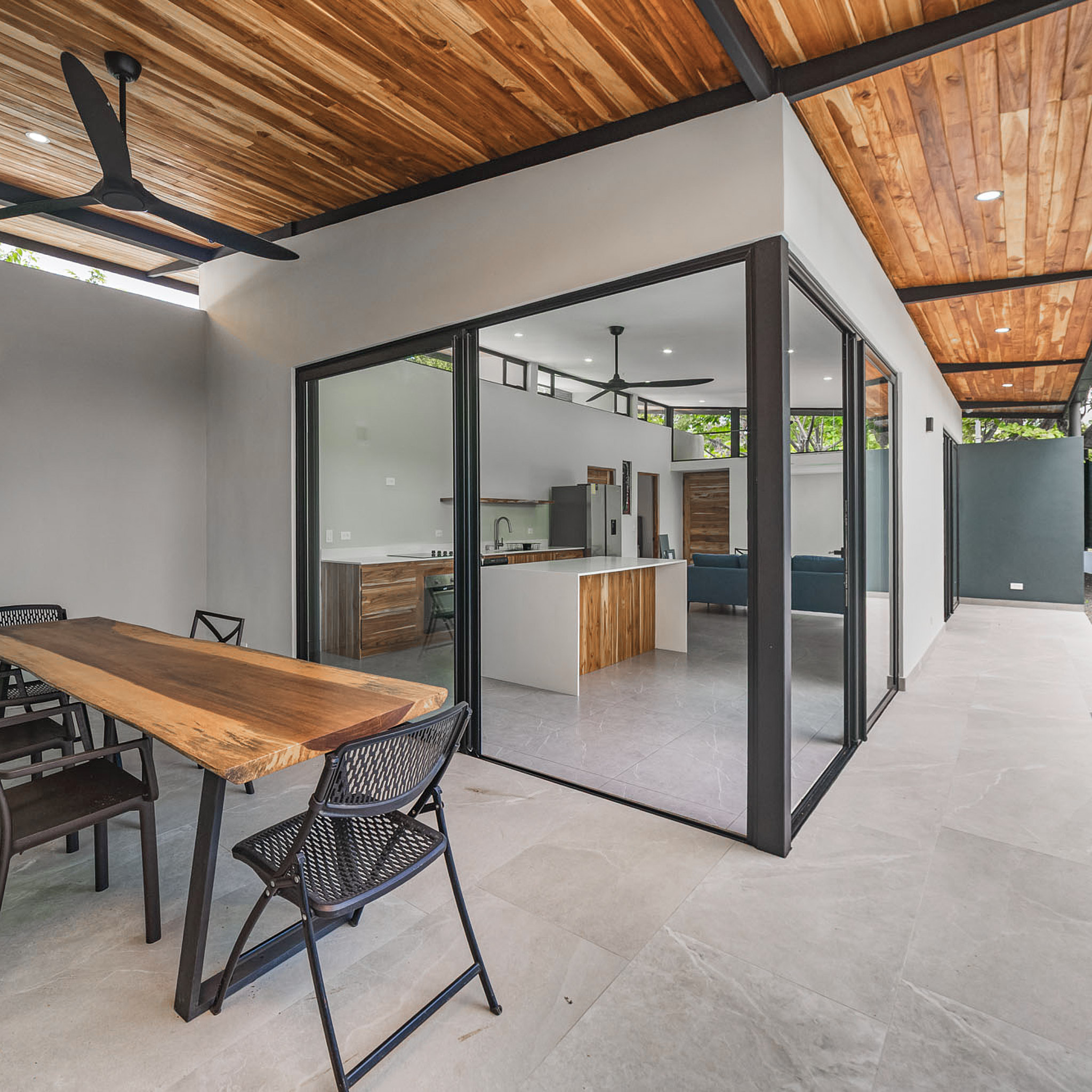 Terrace view looking toward the interior living area beneath the floating roof.